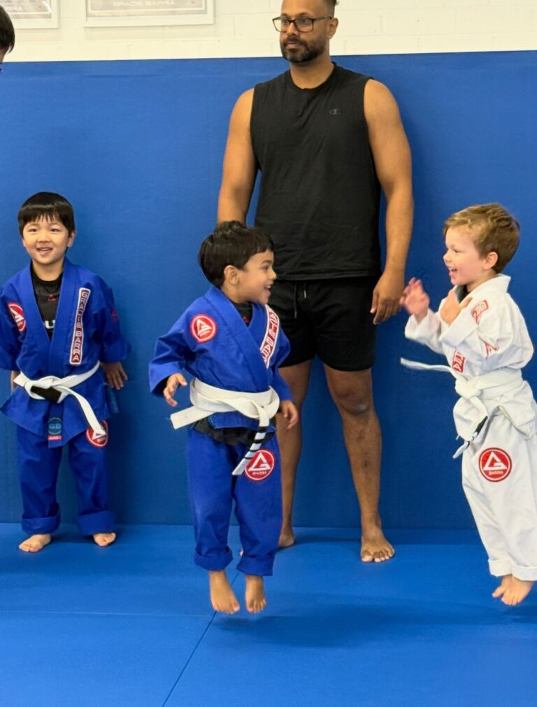 Happy 3 and 4 year old kids jumping during class at Gracie Barra Artarmon